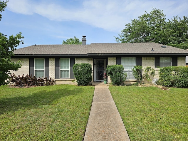 2929 Forest Park Dr, Garland, TX 75040 - ranch-style home with brick siding, a front lawn, a shingled roof, and a chimney