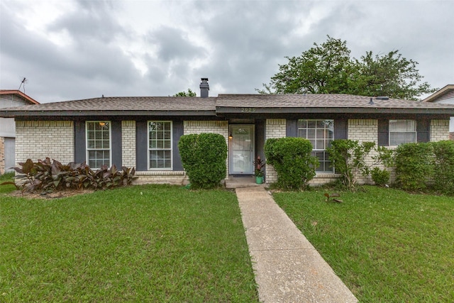 2929 Forest Park Dr, Garland, TX 75040 - ranch-style house with brick siding, a front yard, and roof with shingles