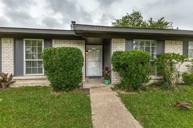 2929 Forest Park Dr, Garland, TX 75040 - property entrance with brick siding and a lawn