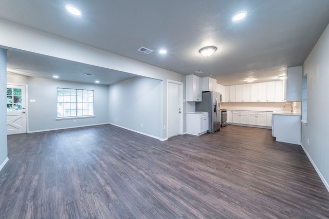 1725 Camara Ct, Grand Prairie, TX 75051 - unfurnished living room featuring baseboards, dark wood-style floors, and recessed lighting