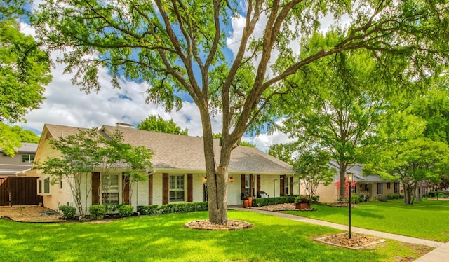 ranch-style house featuring brick siding and a shingled roof