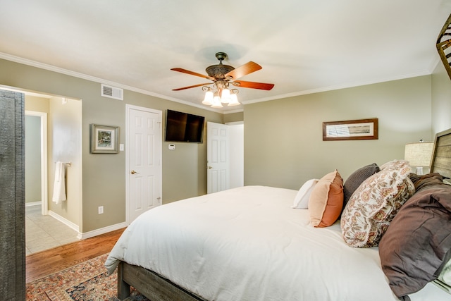 bedroom with light wood-type flooring, ornamental molding, a ceiling fan, and baseboards