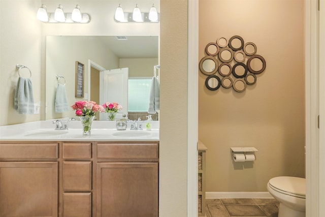 7314 Boulder Star Way, Temple, TX 76502 - bathroom featuring double vanity, toilet, and baseboards