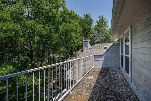 7207 Abrams Place Ct, Dallas, TX 75231 - view of side of property featuring a balcony, roof with shingles, and a chimney