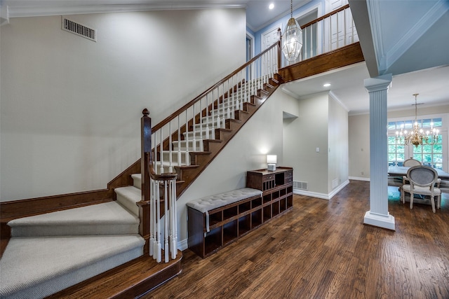 7207 Abrams Place Ct, Dallas, TX 75231 - stairway featuring a chandelier, ornate columns, wood finished floors, ornamental molding, and baseboards