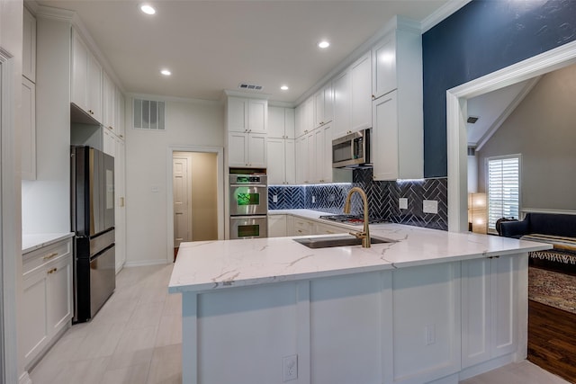 7207 Abrams Place Ct, Dallas, TX 75231 - kitchen featuring stainless steel appliances, a peninsula, backsplash, white cabinetry, and light stone countertops