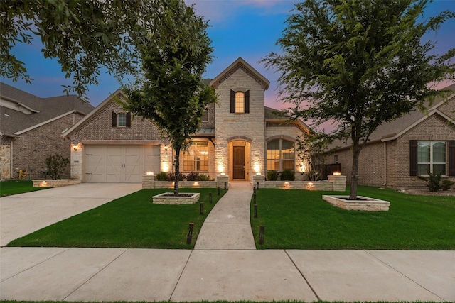 11130 Villa Canales Ln, Frisco, TX 75035 - view of front of house featuring stone siding, a front yard, driveway, and an attached garage