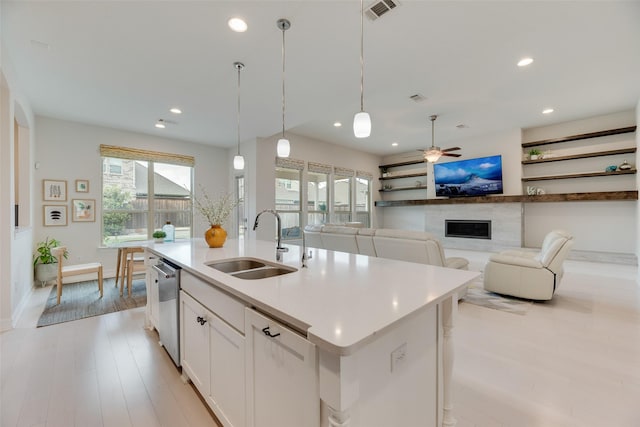 11130 Villa Canales Ln, Frisco, TX 75035 - kitchen with a sink, a high end fireplace, a ceiling fan, recessed lighting, and white cabinets
