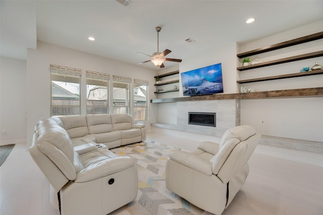 11130 Villa Canales Ln, Frisco, TX 75035 - living room featuring a glass covered fireplace, a ceiling fan, and recessed lighting