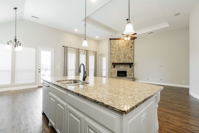 713 Calm Crest Dr, Rockwall, TX 75087 - kitchen featuring a sink, dark wood finished floors, a chandelier, a fireplace, and vaulted ceiling