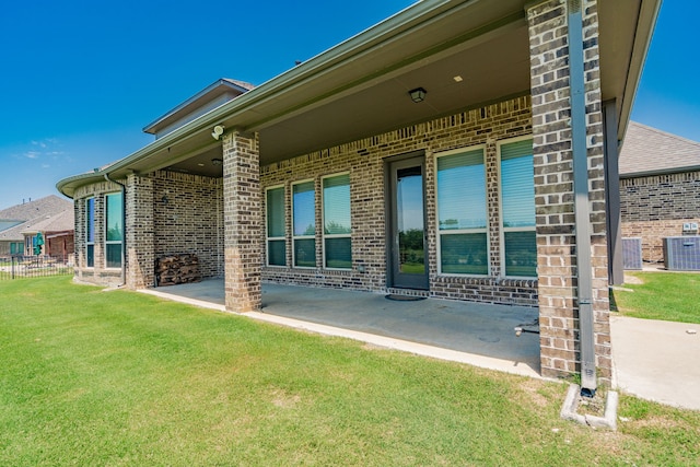 713 Calm Crest Dr, Rockwall, TX 75087 - back of property with brick siding, central AC unit, and a patio area