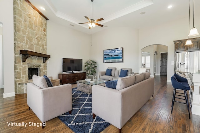713 Calm Crest Dr, Rockwall, TX 75087 - living room with arched walkways, a tray ceiling, ceiling fan, dark wood-style floors, and crown molding