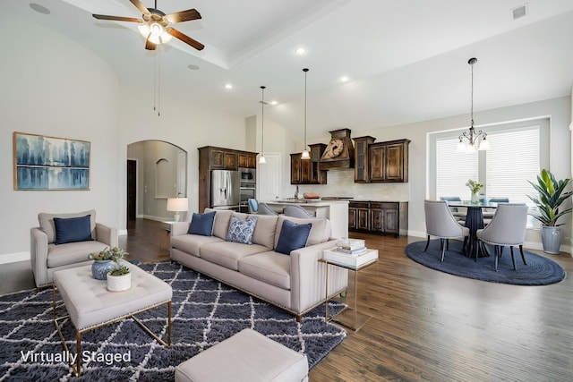 713 Calm Crest Dr, Rockwall, TX 75087 - living room featuring dark wood-style flooring, arched walkways, a ceiling fan, a chandelier, and vaulted ceiling