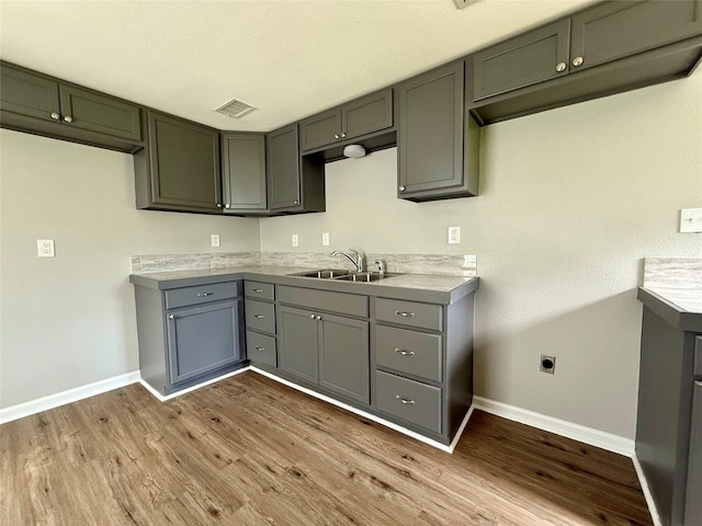 816 Bradleys Bnd, Tool, TX 75143 - kitchen featuring a sink, baseboards, and wood finished floors