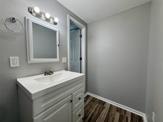 816 Bradleys Bnd, Tool, TX 75143 - bathroom featuring wood finished floors, vanity, and baseboards