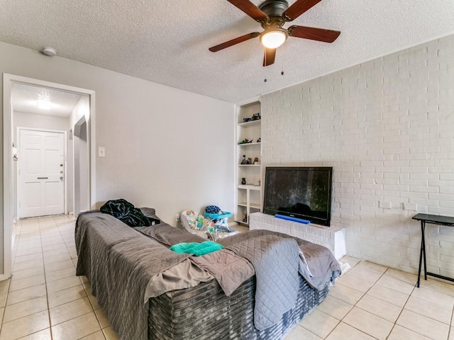 508 Billie Ruth Ln, Hurst, TX 76053 - living room featuring tile patterned floors, a ceiling fan, built in shelves, a textured ceiling, and brick wall