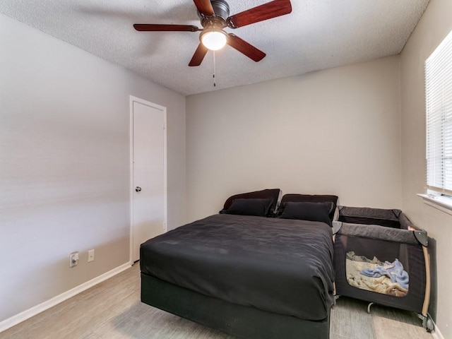 508 Billie Ruth Ln, Hurst, TX 76053 - bedroom with wood finished floors, a textured ceiling, baseboards, and ceiling fan