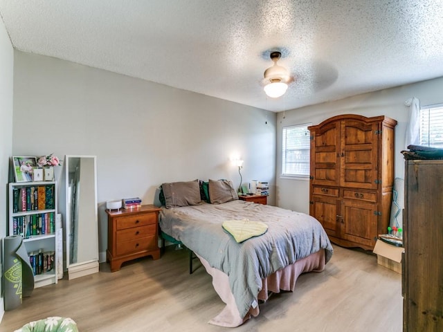 508 Billie Ruth Ln, Hurst, TX 76053 - bedroom with a textured ceiling, light wood-style floors, and a ceiling fan