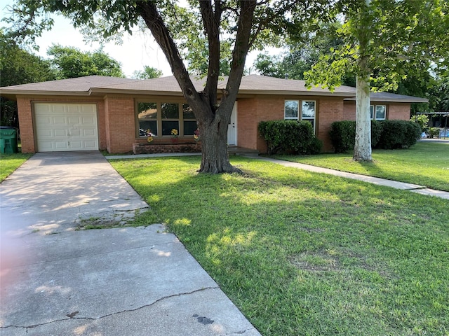 123 Park Dr, Stephenville, TX 76401 - single story home with brick siding, a garage, concrete driveway, and a front yard