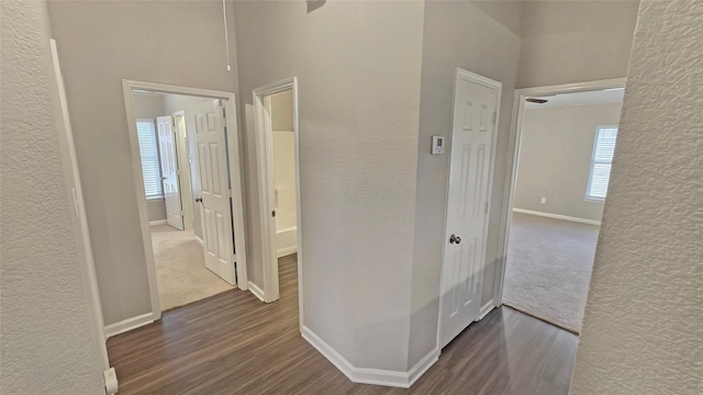 7305 Moon Ridge Ct, Fort Worth, TX 76133 - corridor featuring wood finished floors, a textured wall, and baseboards