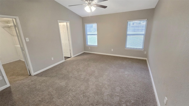 7305 Moon Ridge Ct, Fort Worth, TX 76133 - unfurnished bedroom featuring a walk in closet, carpet flooring, baseboards, lofted ceiling, and ceiling fan