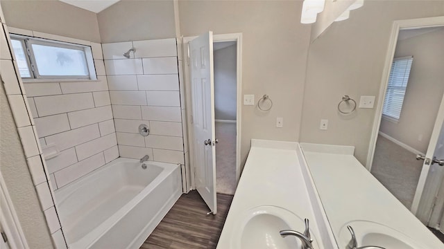 7305 Moon Ridge Ct, Fort Worth, TX 76133 - bathroom featuring shower / bath combination, double vanity, wood finished floors, and baseboards