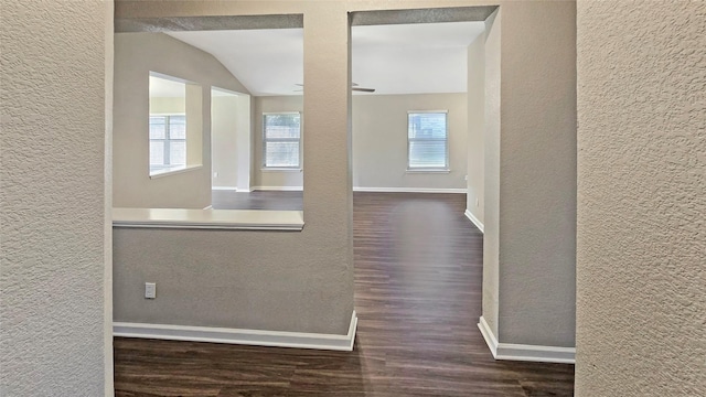 7305 Moon Ridge Ct, Fort Worth, TX 76133 - corridor featuring a textured wall, wood finished floors, baseboards, and vaulted ceiling