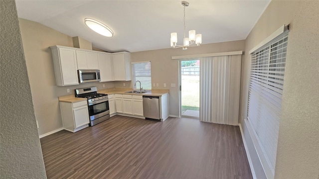 7305 Moon Ridge Ct, Fort Worth, TX 76133 - kitchen with appliances with stainless steel finishes, a sink, light countertops, dark wood finished floors, and lofted ceiling