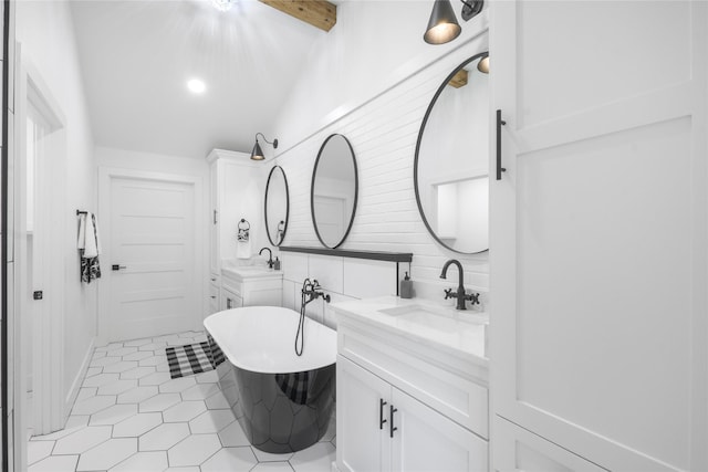 401 Tangle Dr, Tool, TX 75143 - bathroom featuring a freestanding bath, tile patterned flooring, two vanities, and decorative backsplash