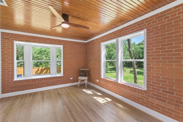 401 Tangle Dr, Tool, TX 75143 - unfurnished room with baseboards, brick wall, wood ceiling, light wood finished floors, and a ceiling fan