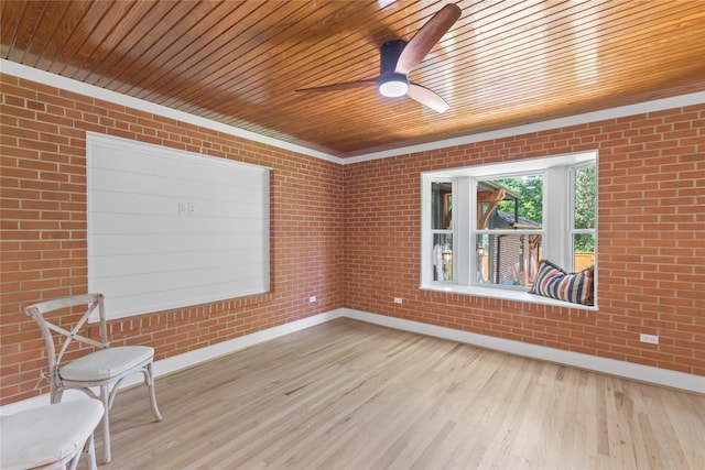 401 Tangle Dr, Tool, TX 75143 - spare room with baseboards, wood finished floors, brick wall, wood ceiling, and a ceiling fan
