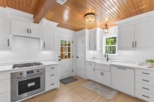 401 Tangle Dr, Tool, TX 75143 - kitchen featuring stainless steel appliances, wooden ceiling, a sink, backsplash, and light countertops