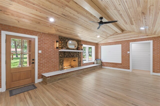 401 Tangle Dr, Tool, TX 75143 - unfurnished living room with brick wall, wood finished floors, a fireplace, wooden ceiling, and plenty of natural light