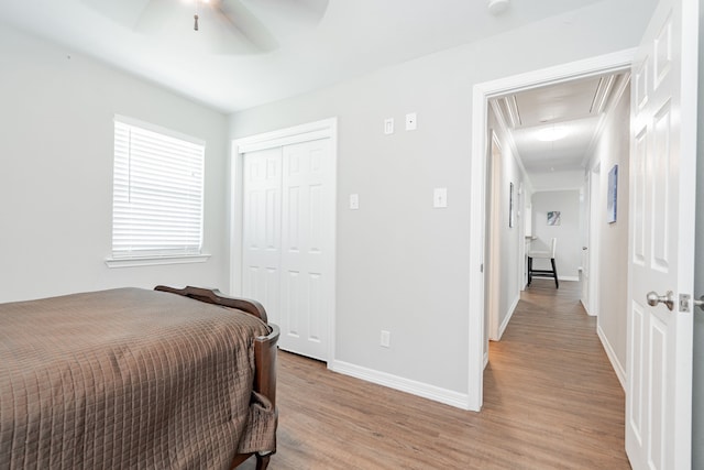 7510 County Road 118, Kaufman, TX 75142 - bedroom with attic access, light wood-type flooring, baseboards, a closet, and a ceiling fan