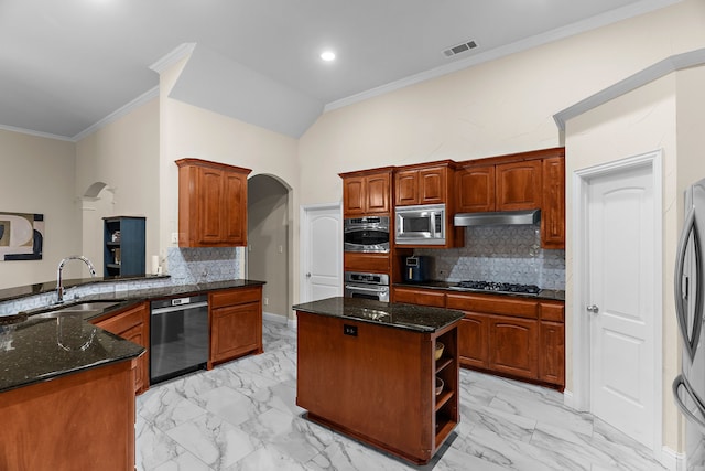 1730 Monaco Dr, Allen, TX 75002 - kitchen featuring appliances with stainless steel finishes, a sink, under cabinet range hood, light marble finish flooring, and arched walkways