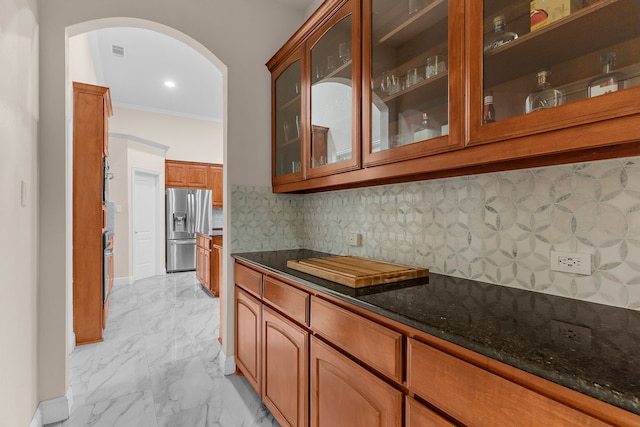 1730 Monaco Dr, Allen, TX 75002 - bar area with stainless steel fridge, arched walkways, light marble finish floors, backsplash, and ornamental molding