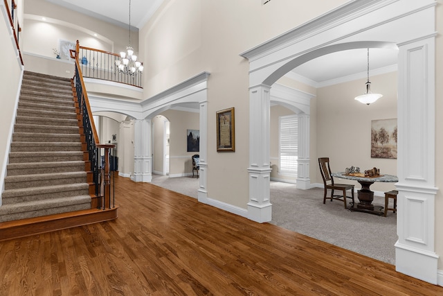 1730 Monaco Dr, Allen, TX 75002 - entryway featuring arched walkways, wood finished floors, ornamental molding, stairway, and ornate columns
