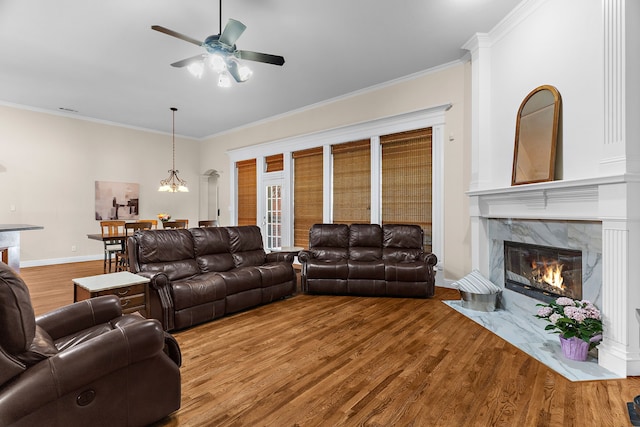 1730 Monaco Dr, Allen, TX 75002 - living area with wood finished floors, crown molding, a ceiling fan, and a high end fireplace