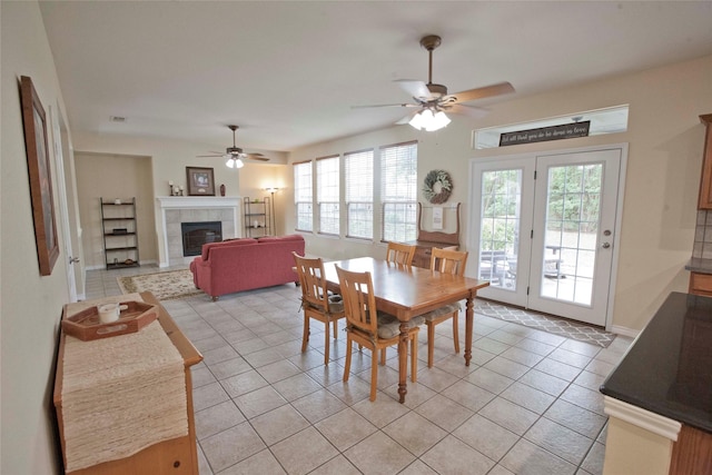 908 Reveille Rd, Fort Worth, TX 76108 - dining space with ceiling fan, healthy amount of natural light, a tile fireplace, and light tile patterned floors