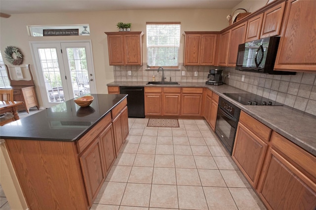 908 Reveille Rd, Fort Worth, TX 76108 - kitchen featuring black appliances, a sink, tasteful backsplash, light tile patterned floors, and dark countertops