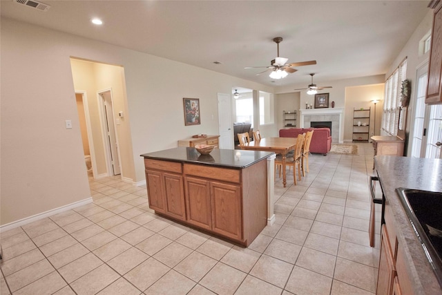 908 Reveille Rd, Fort Worth, TX 76108 - kitchen featuring light tile patterned flooring, a ceiling fan, a fireplace, dark countertops, and recessed lighting