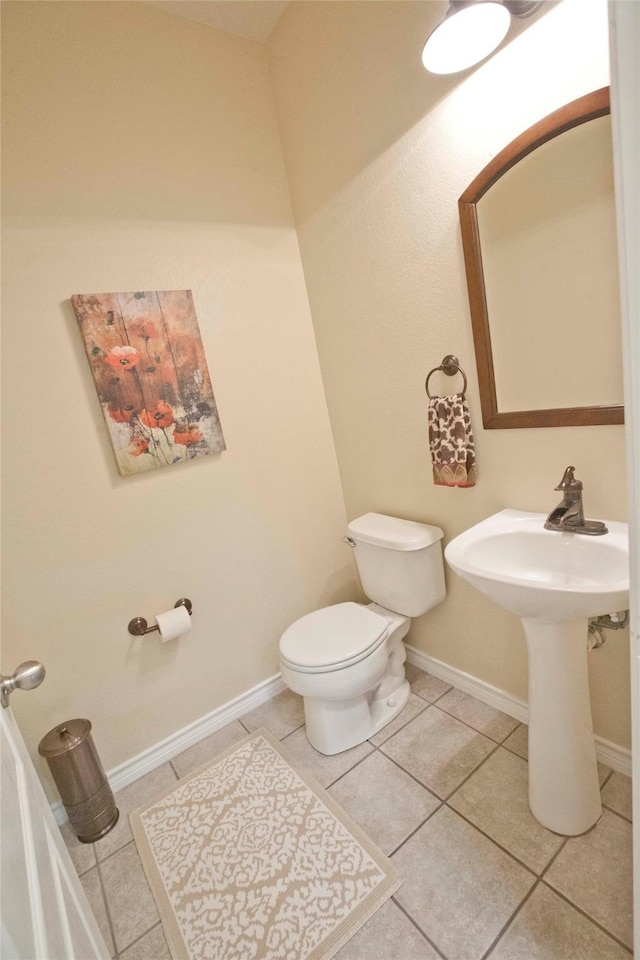 908 Reveille Rd, Fort Worth, TX 76108 - half bathroom featuring toilet, tile patterned flooring, and baseboards