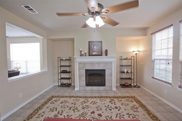 908 Reveille Rd, Fort Worth, TX 76108 - living room with ceiling fan, a fireplace, tile patterned flooring, and baseboards