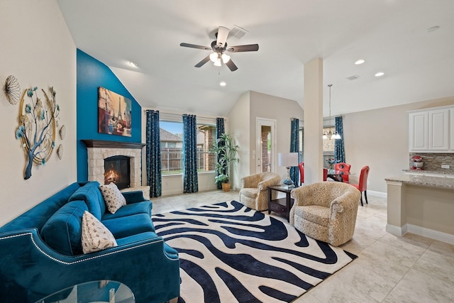 1109 Hot Springs Way, Celina, TX 75009 - living area featuring a ceiling fan, light tile patterned floors, baseboards, a tiled fireplace, and vaulted ceiling