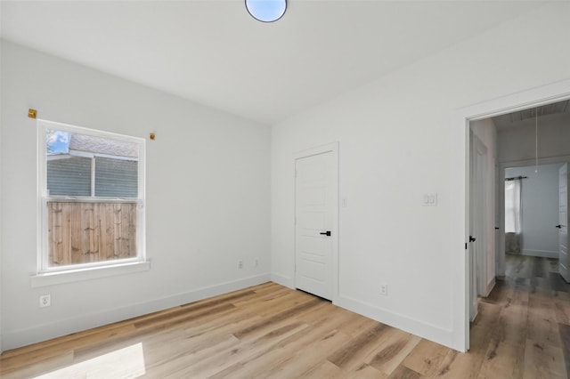 2927 Valentine St, Dallas, TX 75215 - unfurnished bedroom with light wood-type flooring, baseboards, and attic access