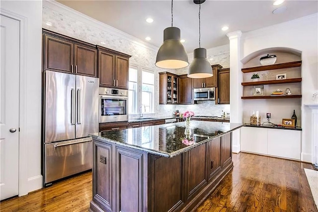 3660 Belvedere Ct, Dallas, TX 75219 - kitchen featuring appliances with stainless steel finishes, dark stone countertops, dark brown cabinetry, open shelves, and dark wood-type flooring