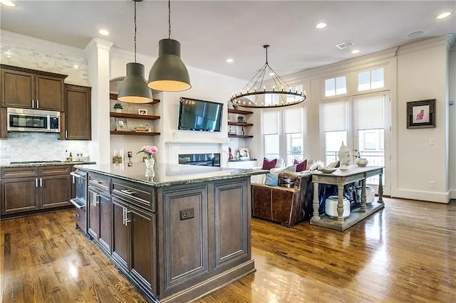 3660 Belvedere Ct, Dallas, TX 75219 - kitchen with appliances with stainless steel finishes, open shelves, dark brown cabinetry, dark wood finished floors, and hanging light fixtures