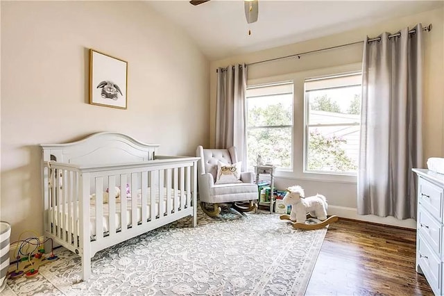 3660 Belvedere Ct, Dallas, TX 75219 - bedroom with lofted ceiling, a crib, wood finished floors, ceiling fan, and baseboards