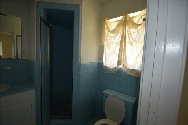 112 Big Bass Rd, West, TX 76691 - bathroom featuring a stall shower, vanity, tile walls, wainscoting, and toilet