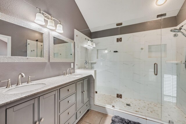 2775 Sweetbriar Ln, Grand Prairie, TX 75052 - full bathroom with vaulted ceiling, a shower stall, tile patterned floors, and double vanity